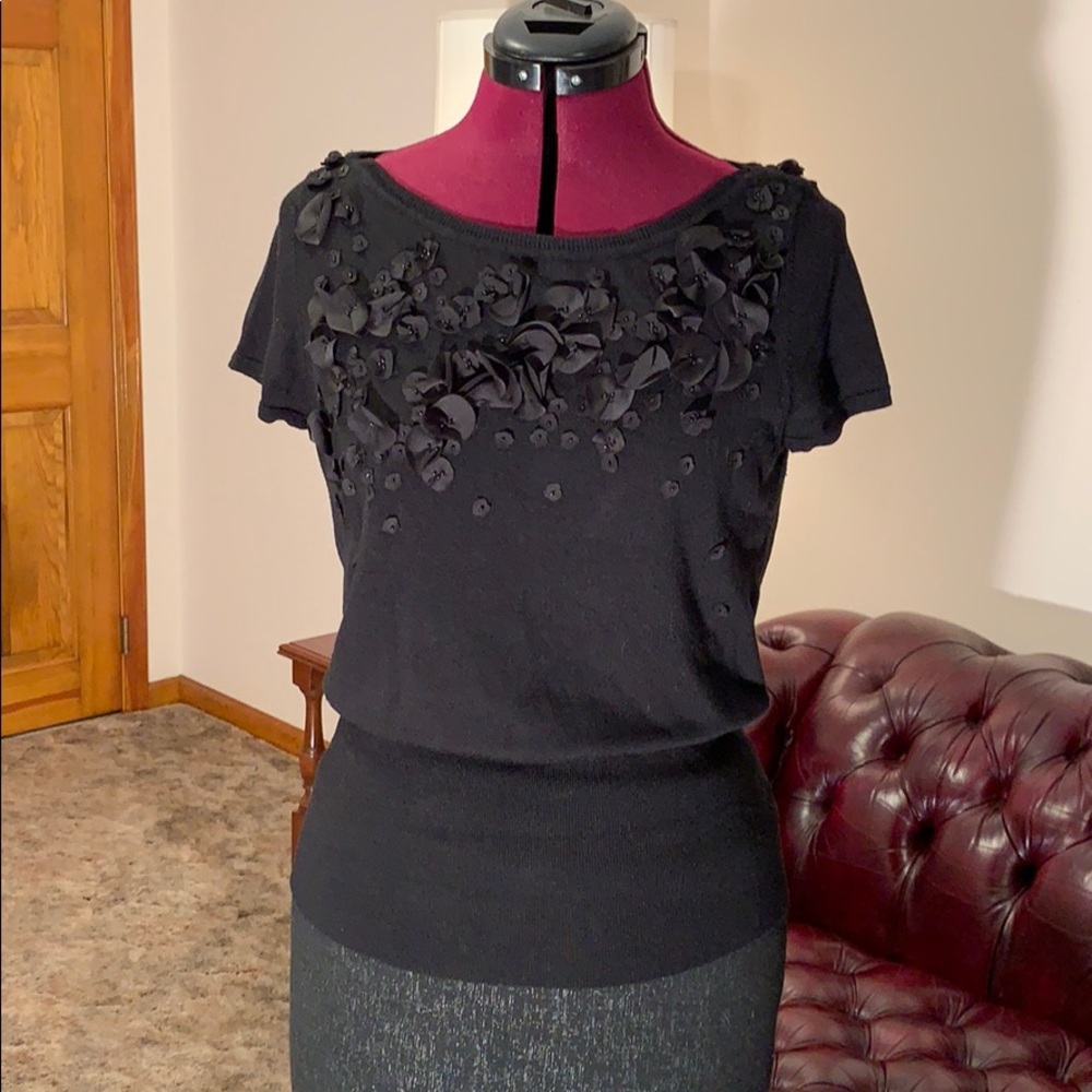 Short sleeved black sweater.